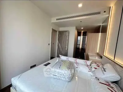 Modern bedroom with sleek design and ample natural light, featuring a comfortable bed and stylish decor.