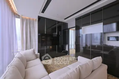 Luxurious modern living room with sleek black cabinetry and plush beige sofa