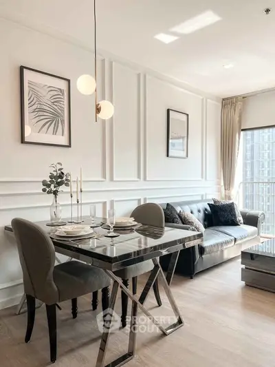 Elegant modern living room with dining area, featuring stylish decor and natural light.