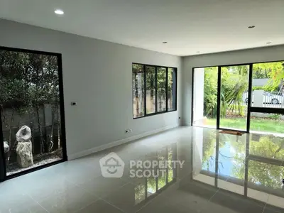 Spacious modern living room with large windows and garden view