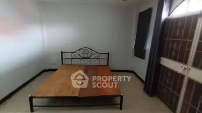 Spacious bedroom with metal bed frame and natural light