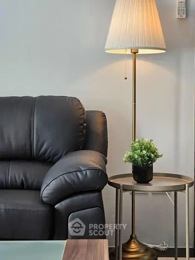 Cozy living room corner with leather sofa and elegant lamp