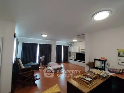 Spacious living room with modern furnishings and ample natural light, perfect for relaxation and entertainment.
