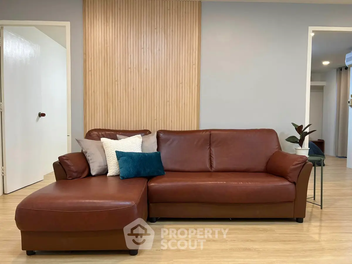 Stylish living room with a modern brown leather sofa and elegant decor.