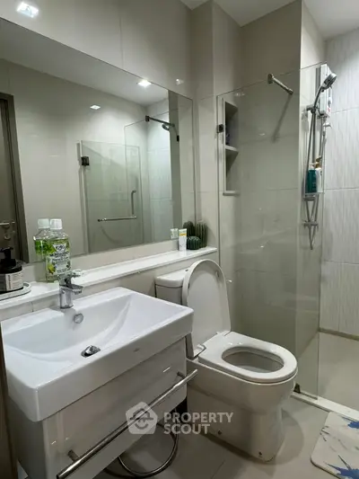 Modern bathroom with sleek fixtures and glass shower enclosure