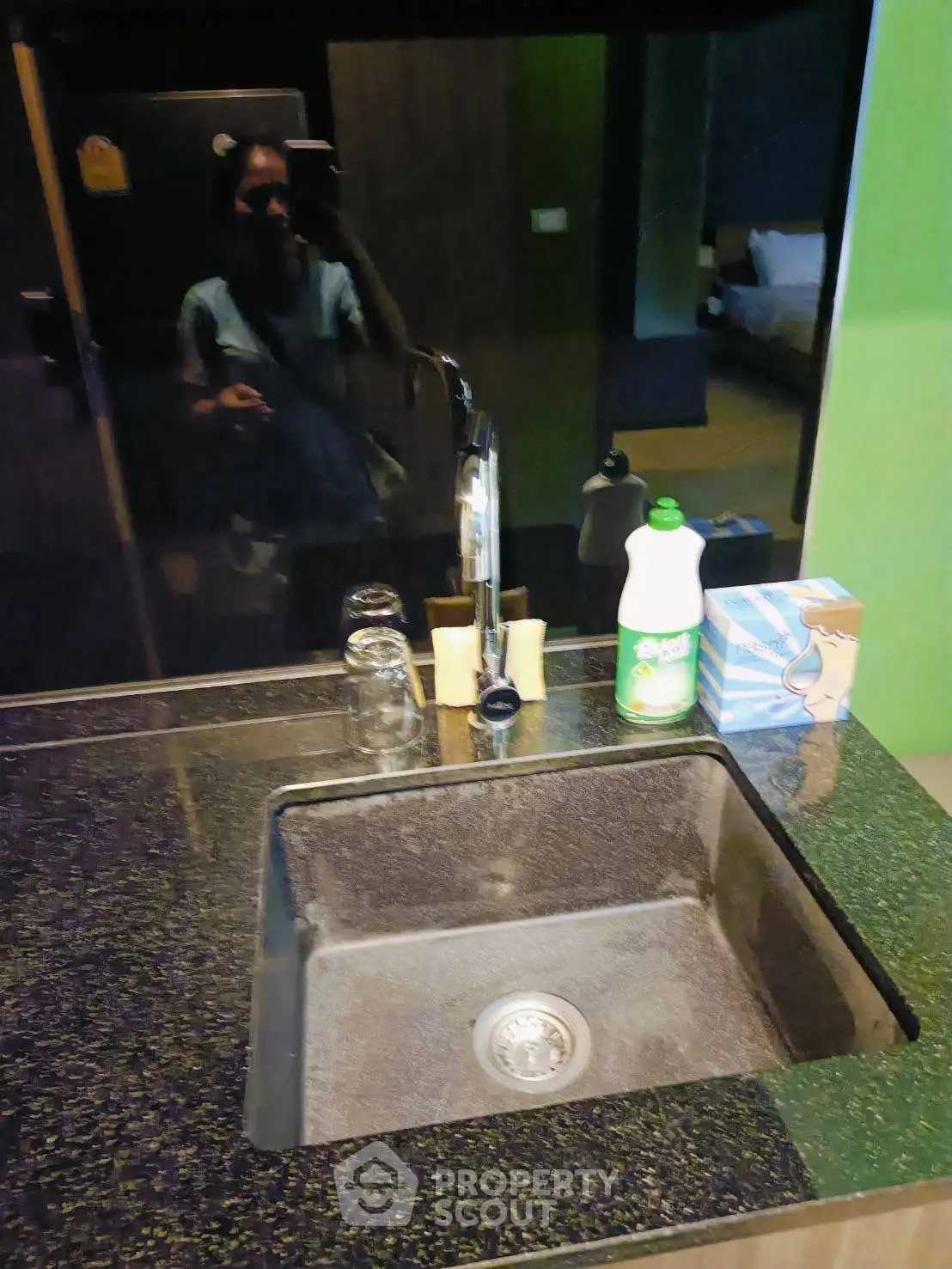 Modern kitchen sink with sleek countertop and stylish faucet in contemporary home.
