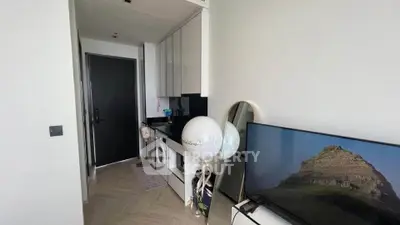 Modern apartment interior with washing machine and TV, sleek design