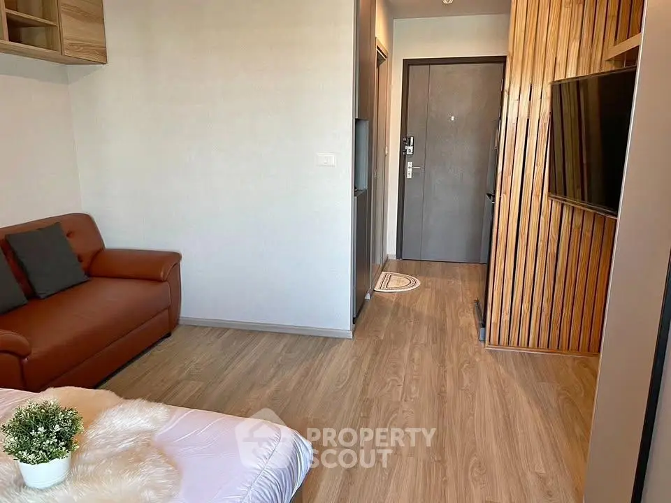 Modern living room with wooden flooring and stylish decor in a cozy apartment.