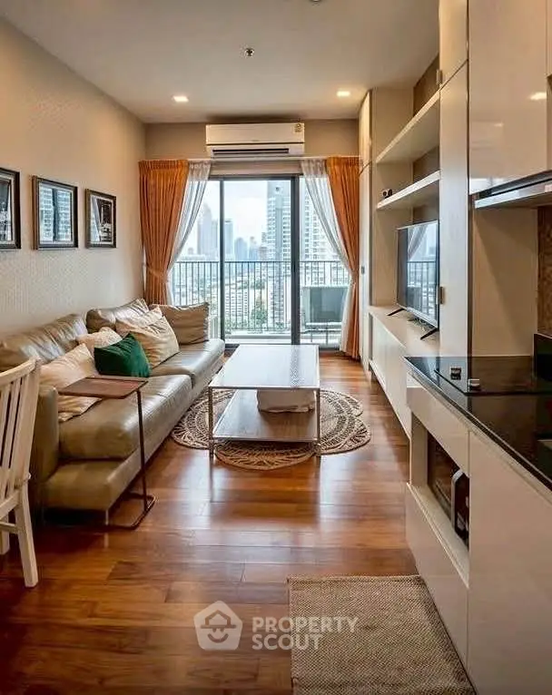 Stylish living room with city view, modern furnishings, and wooden flooring in a high-rise apartment.