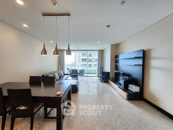 Spacious modern living room with elegant dining area and large windows.