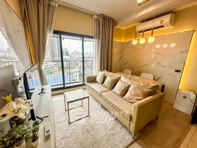 Modern living room with city view, stylish decor, and cozy seating area.