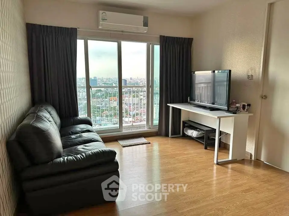 Modern living room with city view, leather sofa, and large TV, perfect for urban living.