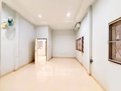 Spacious unfurnished room with tiled flooring and large windows, perfect for customization.