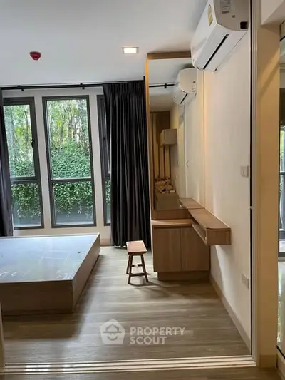 Modern bedroom with large windows and stylish wooden furniture