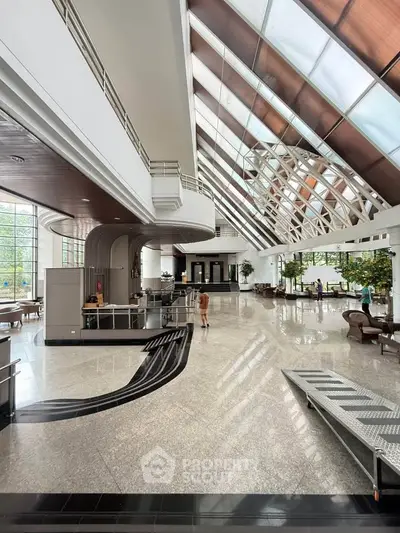 Spacious and elegant lobby with modern architectural design and abundant natural light.