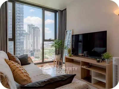 Modern living room with large windows offering stunning city views, stylish decor, and a cozy ambiance.