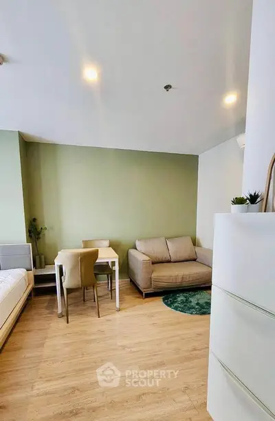 Modern living room with cozy sofa, dining table, and stylish decor in a bright apartment.