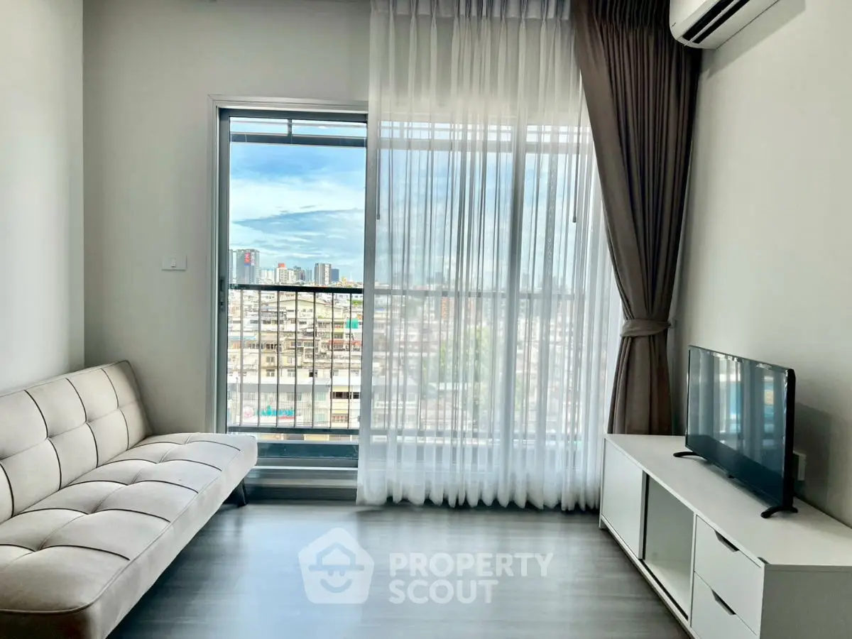 Modern living room with city view, featuring sleek sofa and TV setup.
