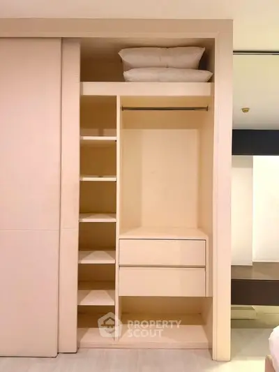 Spacious built-in wardrobe with shelves and drawers in modern apartment