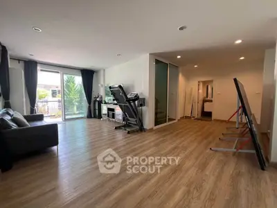 Spacious living room with modern decor and large windows offering natural light.