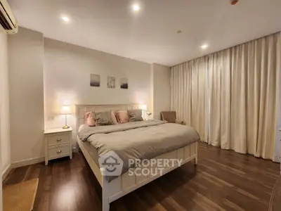 Spacious and cozy bedroom with elegant decor and soft lighting, perfect for relaxation.