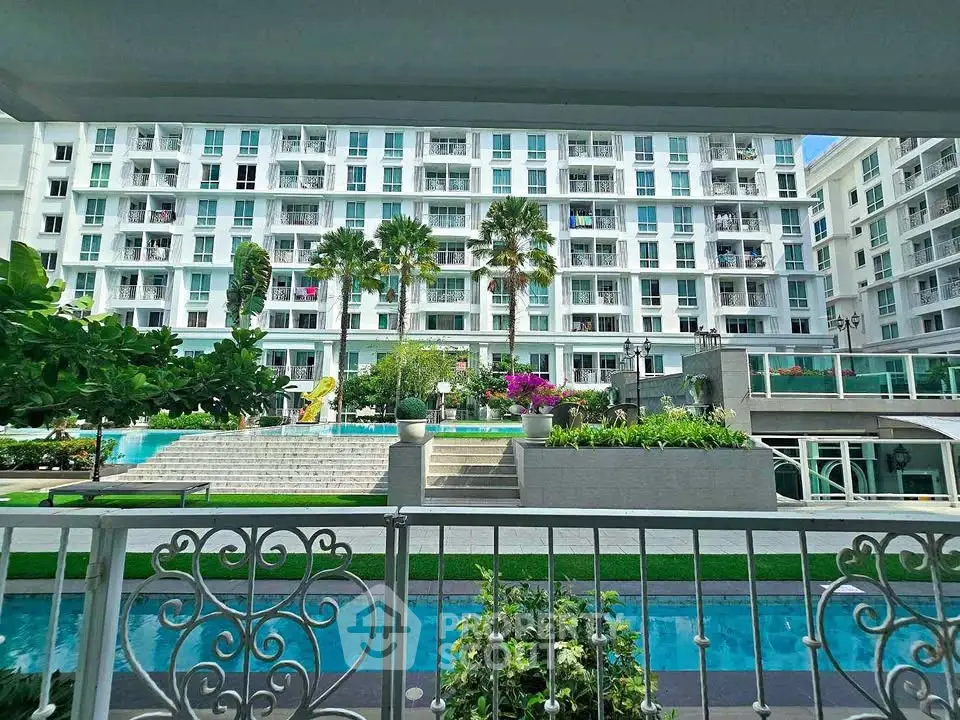 Luxurious apartment complex with pool and lush gardens, offering a serene and upscale living environment.