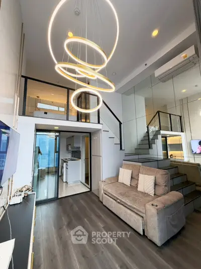 Modern loft-style living room with high ceilings and elegant lighting