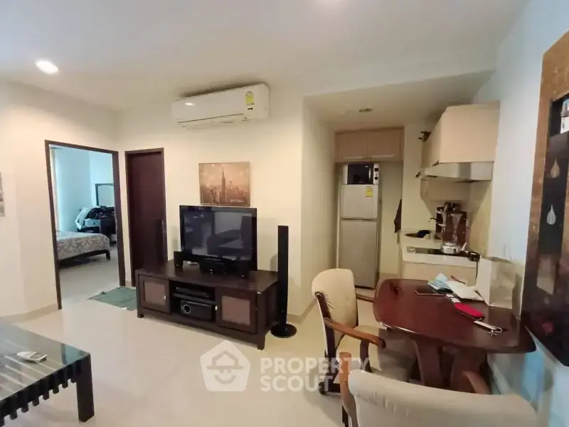 Cozy living room with dining area and modern appliances in a stylish apartment.