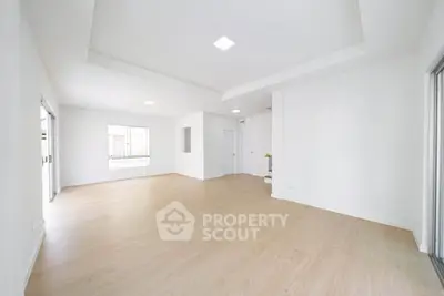 Spacious and bright living room with modern design and large windows.