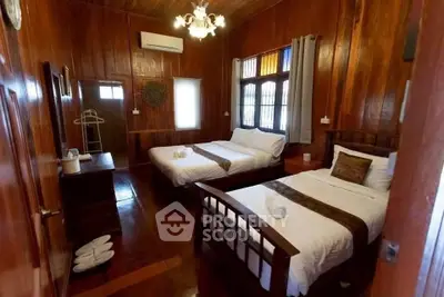 Charming wooden bedroom with two cozy beds and warm lighting