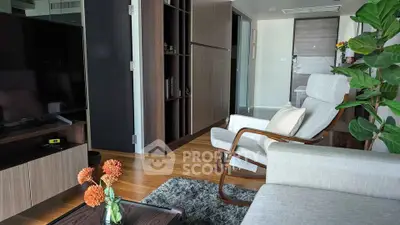 Modern living room with sleek furniture and wooden flooring