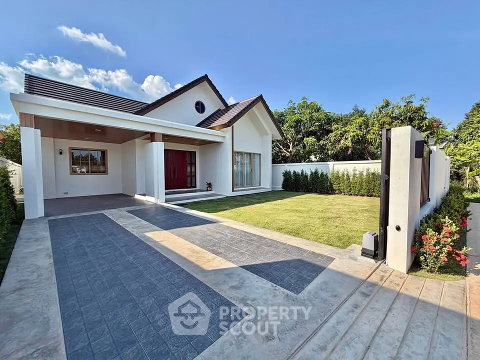 Charming modern house with spacious driveway and lush green lawn under a clear blue sky.