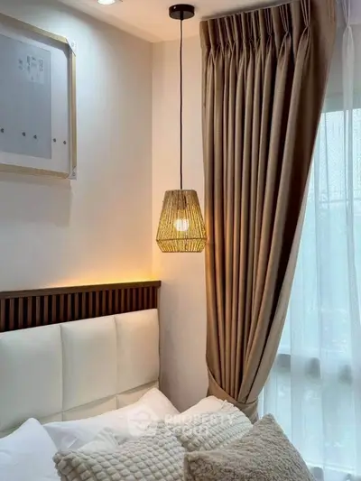 Cozy bedroom with elegant pendant light and plush pillows