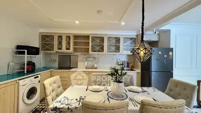 Charming kitchen with dining area, featuring modern appliances and elegant decor.
