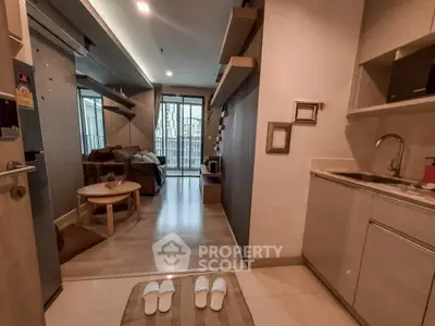 Modern apartment interior with cozy living room and kitchen, featuring sleek design and natural light.