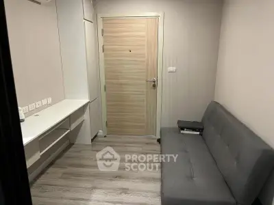 Cozy study room with modern sofa and built-in desk, perfect for productivity.