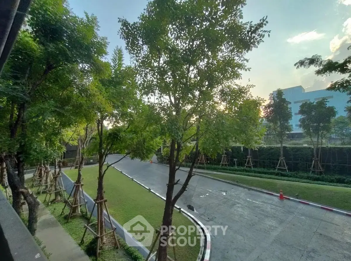 Serene residential garden view with lush trees and well-maintained pathways.