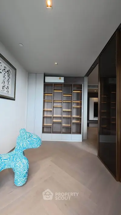 Spacious modern living area with stylish shelving and unique decor piece
