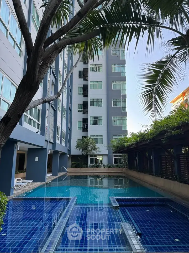 Luxurious apartment building with stunning pool and lush greenery