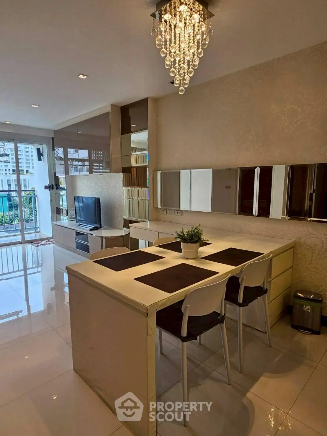 Modern kitchen with elegant chandelier and sleek design in urban apartment