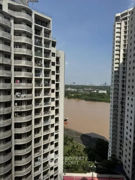 Stunning high-rise apartment view with river and cityscape backdrop