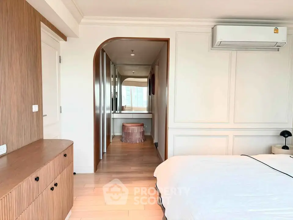 Elegant bedroom with modern design, featuring wooden accents and a cozy ambiance, perfect for relaxation.