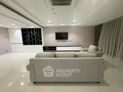 Spacious modern living room with sleek furniture and built-in shelving, perfect for contemporary living.