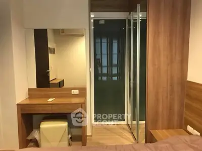 Modern bedroom with wooden furniture and mirrored wardrobe