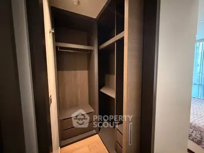 Spacious walk-in closet with modern wooden shelving and ample storage space.