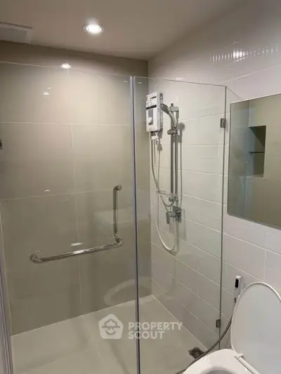 Modern bathroom with glass shower enclosure and sleek fixtures