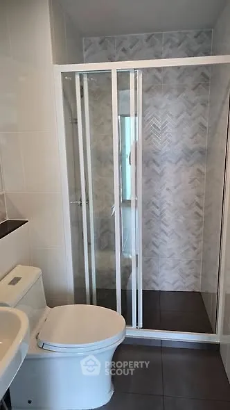 Modern bathroom with glass shower and sleek tile design