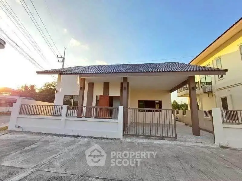 Charming single-story house with modern design and spacious driveway in a serene neighborhood.