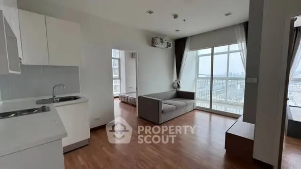 Spacious modern apartment with open layout and large windows offering stunning city views.