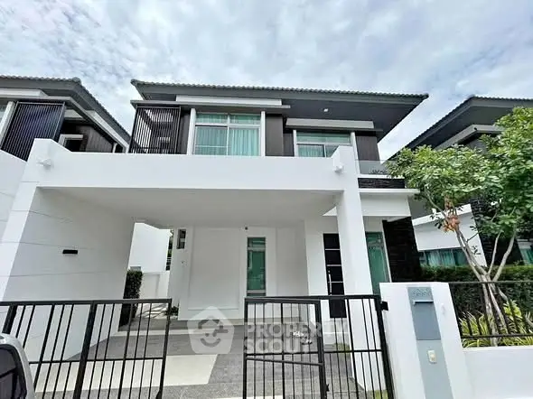 Modern two-story house with sleek design and spacious driveway